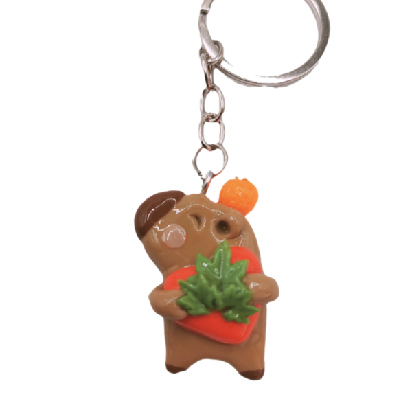 Llavero de capybara sosteniendo marihuana y un corazón rojo, hecho a mano.
